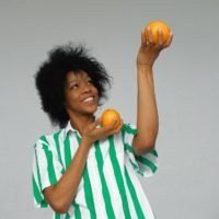 Photo Of Smiling Woman In White And Green Stripe Shirt